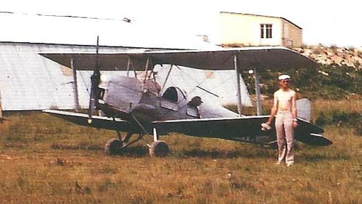 Stampe et pilote devant le hangar